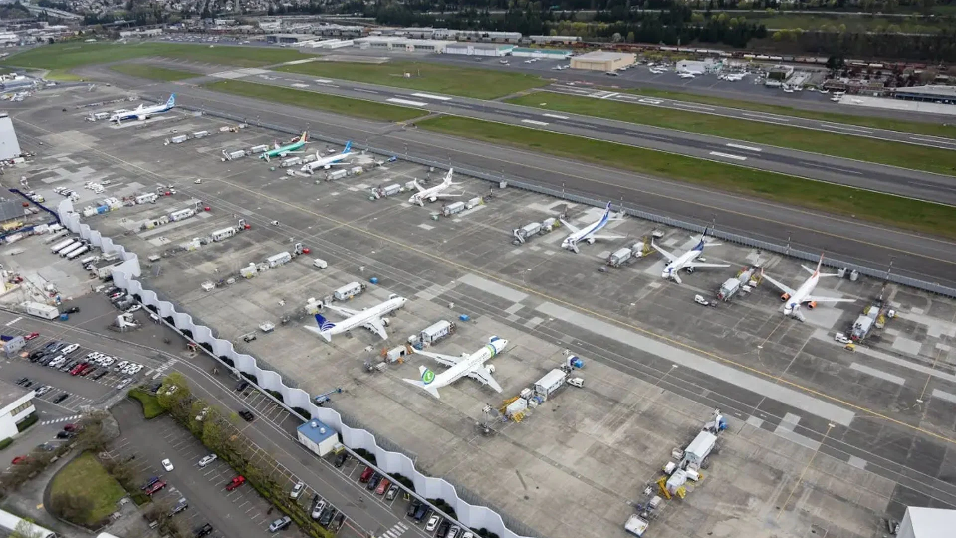 Private jet at Boeing Field with luxury chauffeur SUV ready for FBO transfer